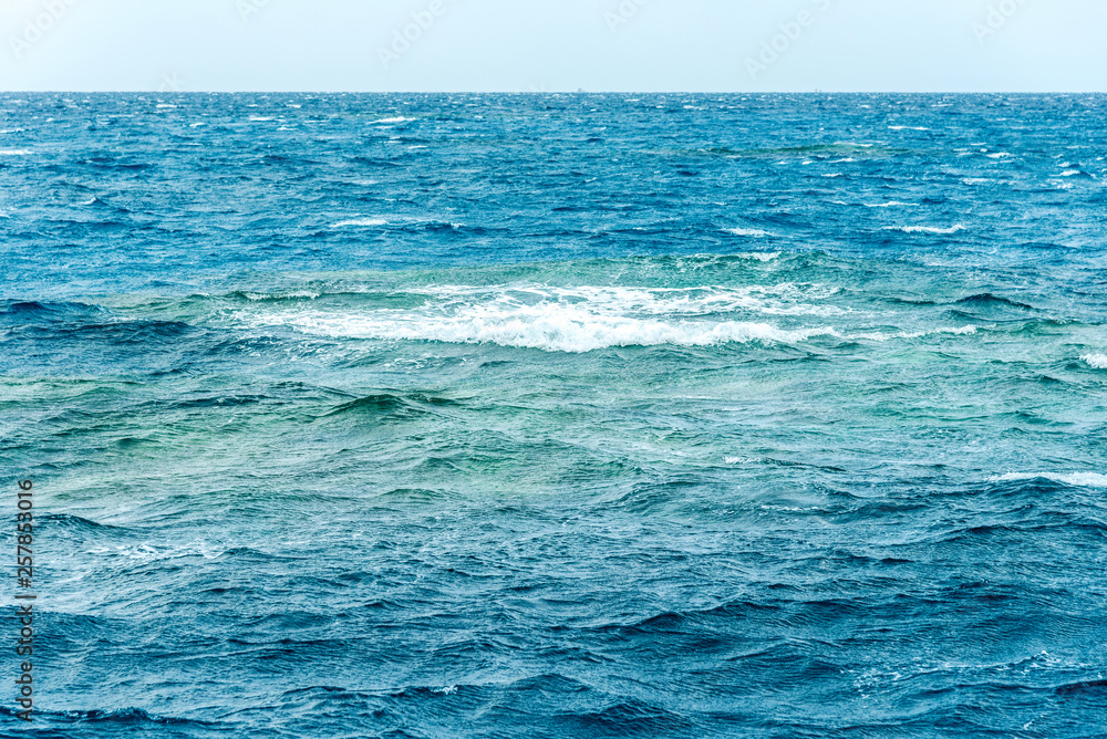 Fototapeta premium minimalistic seascape, blue sea and sky with white clouds on the whole frame