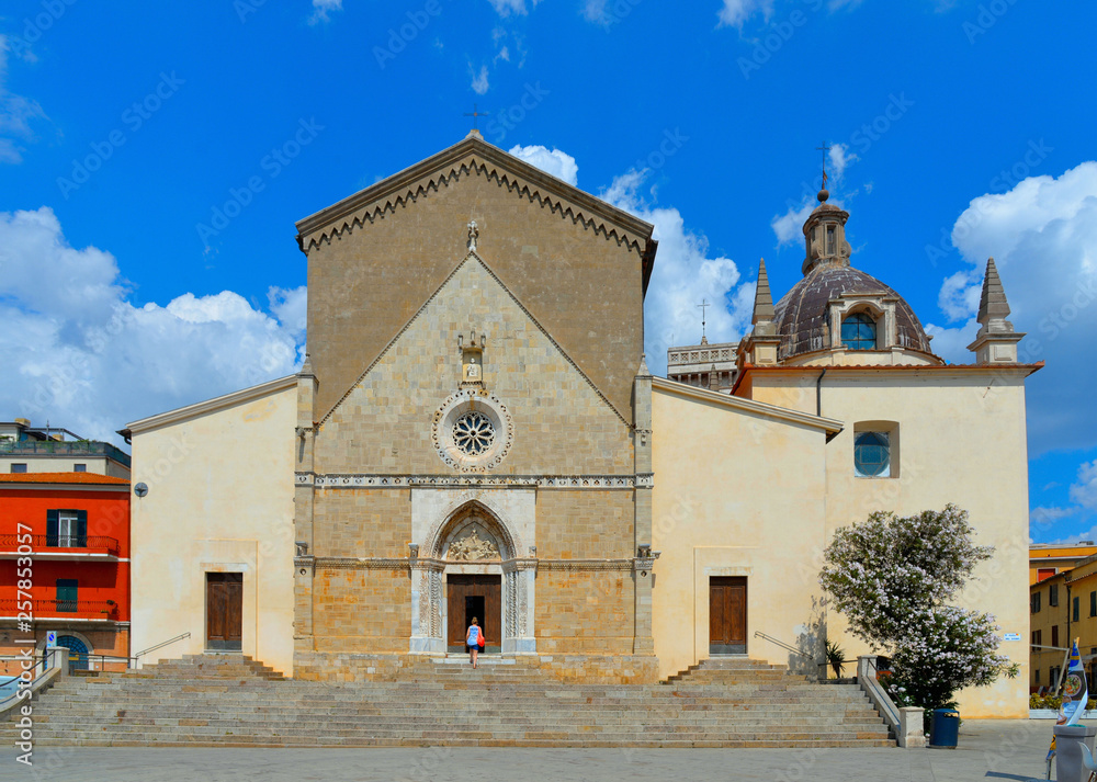 Fototapeta premium Detail of Orbetello Cathedral, Concattedrale di Santa Maria Assunta and city scape and buildings with blue cloudy sky in summer day, Grosseto Tuscany Italy