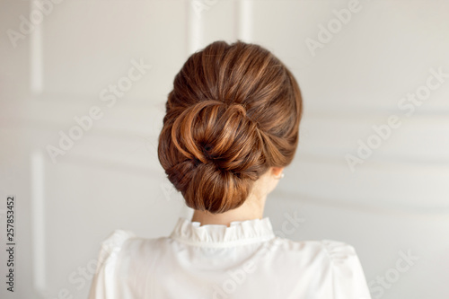 Rear view of female hairstyle middle bun with brown hair