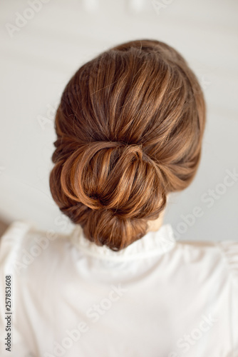 Rear view of female hairstyle middle bun with brown hair
