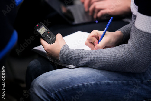 Valokuvatapetti a voice recorder in the hand of a journalist