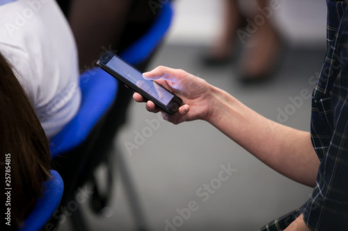 close up investor man hand gesture hold mobile phone device for reading or write digital content concept.