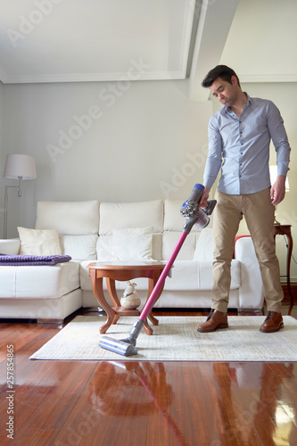 man vacuuming without wires.