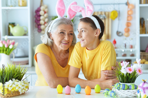 Happy senior woman with grandson wearing rabbit ears