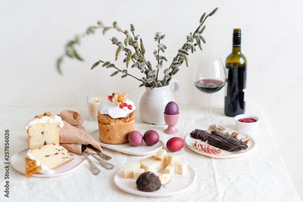 Serving Easter table with tasty dishes and glass of wine Serving Easter table with tasty dishes and glass of wine
