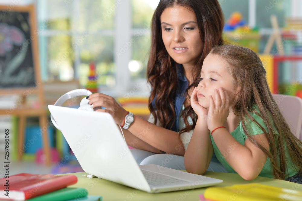 Portrait of happy mother and daughter using laptop Portrait of happy mother and daughter using laptop