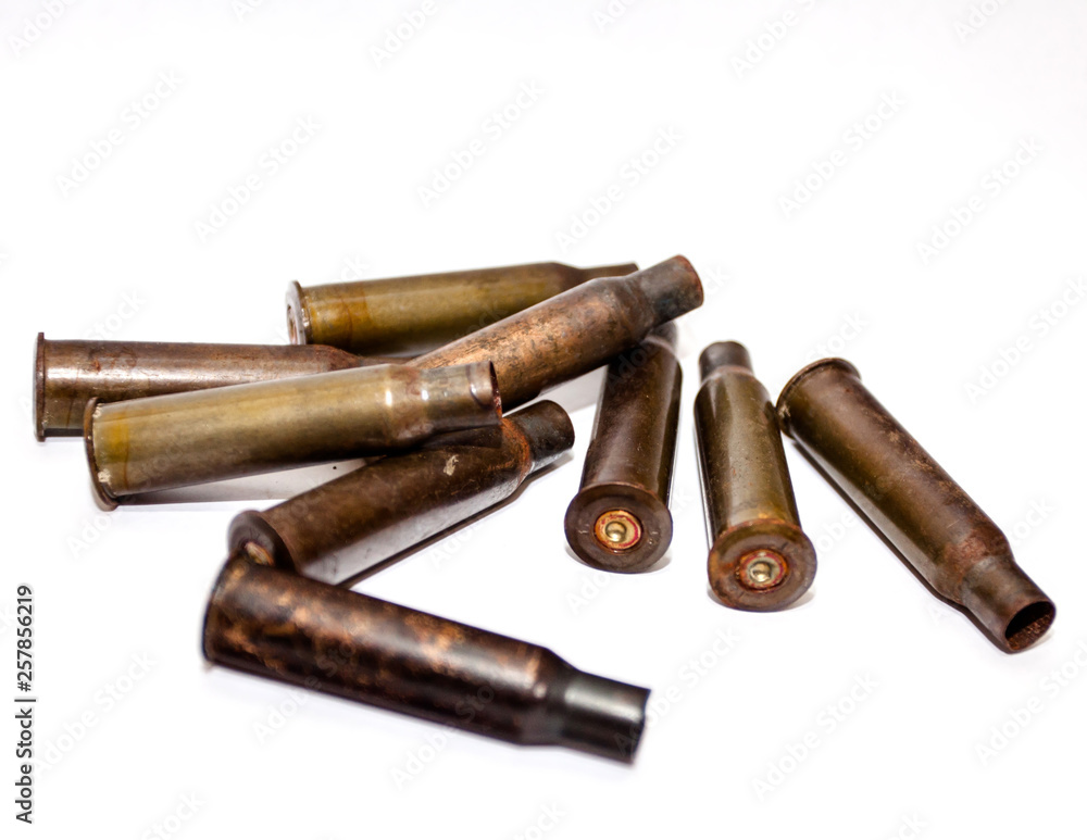 A pile bullet shells on a white background