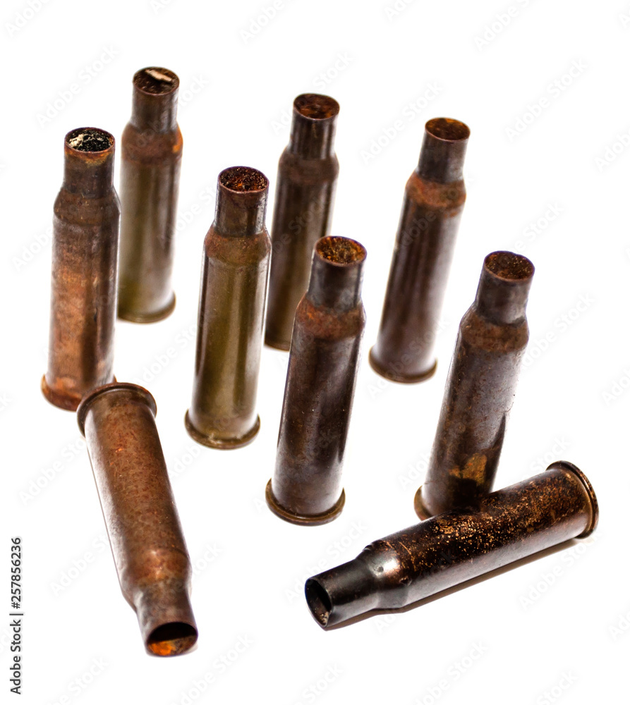 A pile bullet shells on a white background A pile bullet shells on a white background