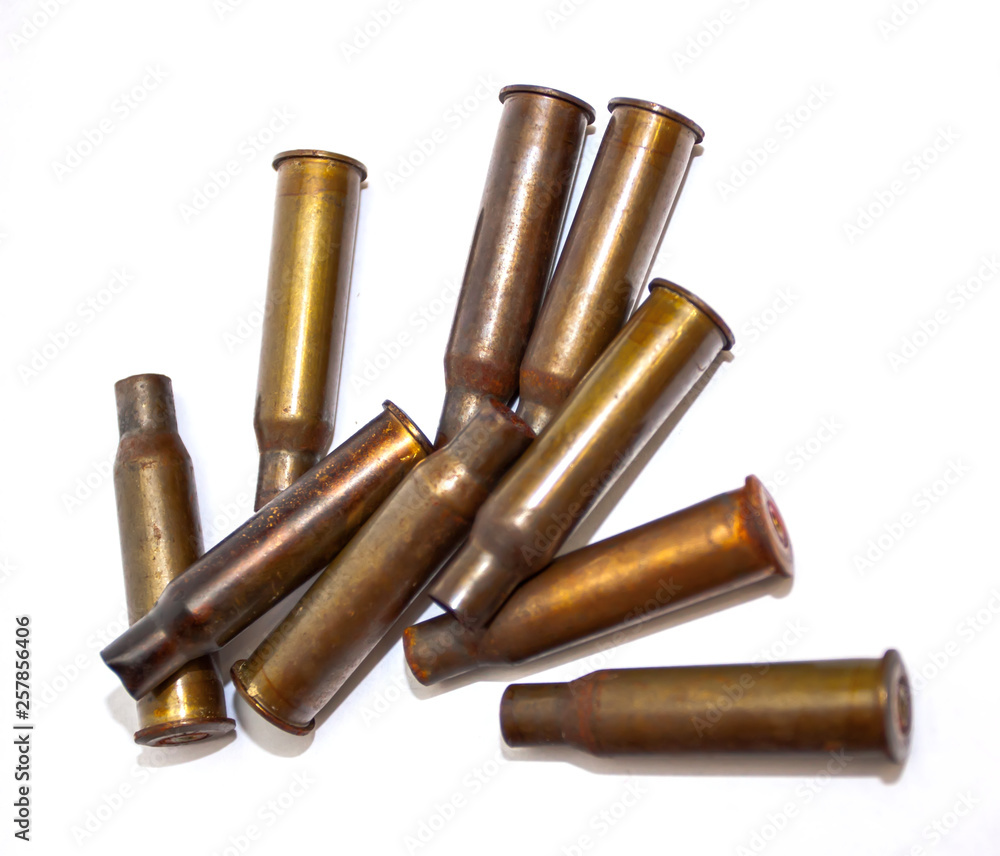 A pile bullet shells on a white background
