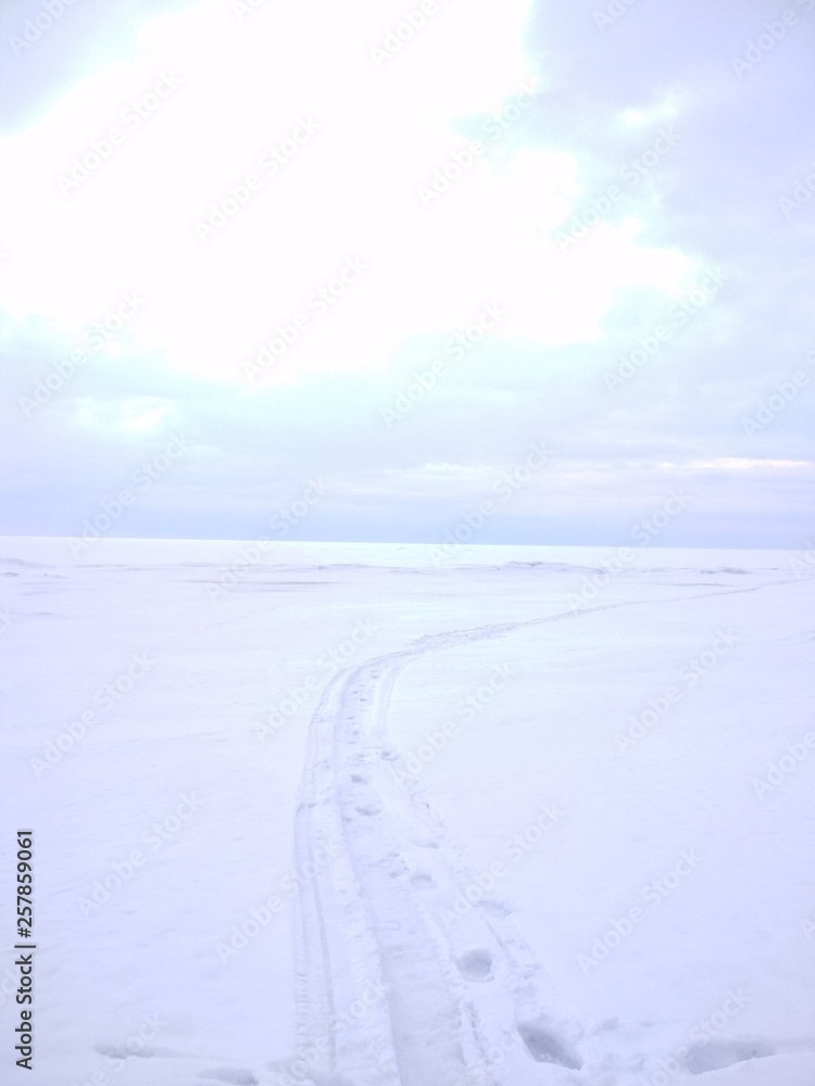 Snow, white sky and earth path