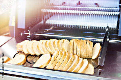 Sliced bread in cutting machine photo