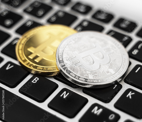 Bitcoin coins cryptocurrency on the laptop keyboard.