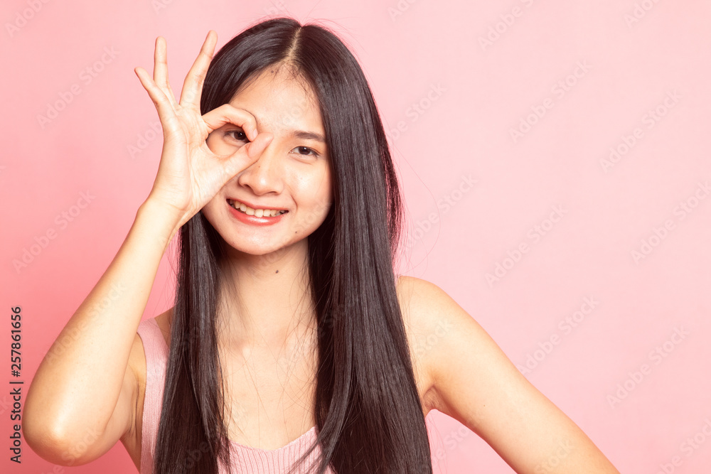 Beautiful young Asian woman show OK sign over her eye. Beautiful young Asian woman show OK sign over her eye.