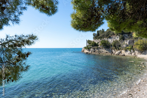 Fototapeta Naklejka Na Ścianę i Meble -  Beautiful sunny rocky beach in Miramare's park, Trieste Italy