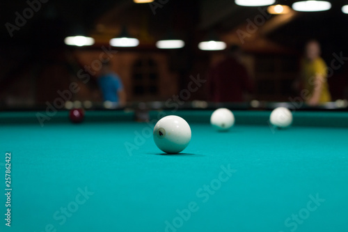 Russian billiards in club: balls on green game table