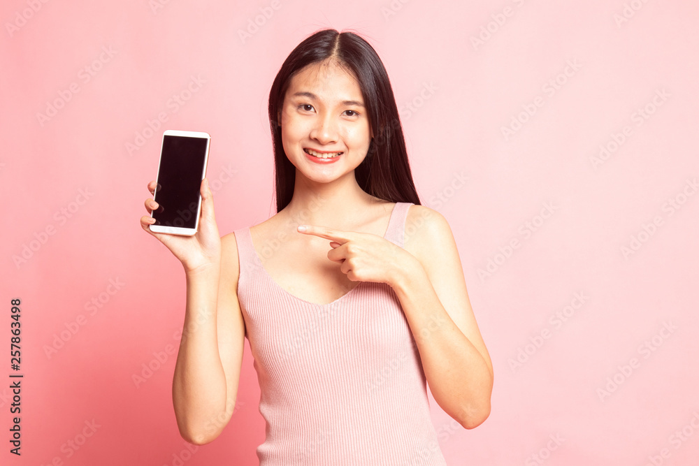 Young Asian woman point to mobile phone. Young Asian woman point to mobile phone.