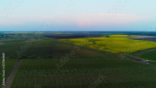 Aerial View In Cloudy Weather. View Of Agricultural Land In Europe With Orchards And Fields.