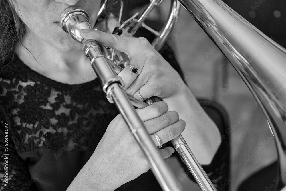 Obraz premium Hands of a girl playing the trombone Black and white image