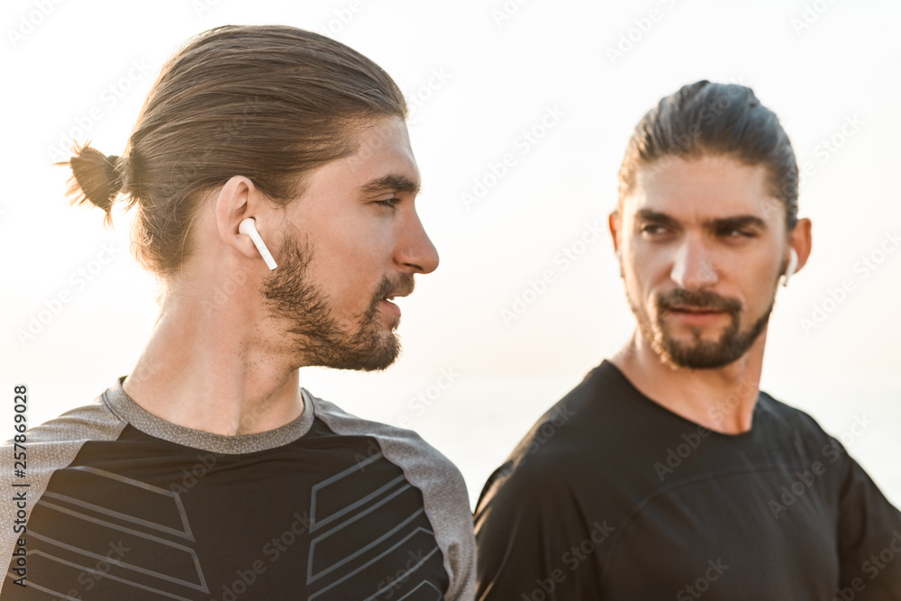 Two twin brothers doing exercises at the beach Two twin brothers doing exercises at the beach