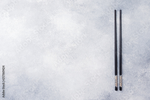 Chopsticks on concrete background with copy space.