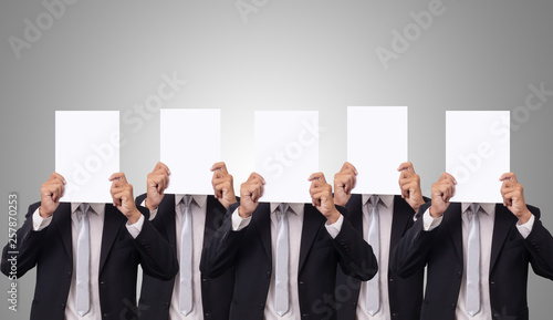 five Asian businessman cover her face with blank empty white paper for hide emotion photo