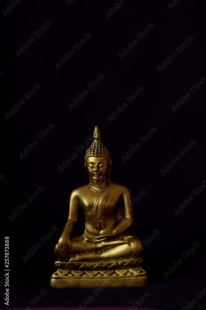 statue of buddha on dark background
