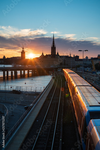 Sunset view of Gamla Stan and Stockholm metro train from Slussen photo