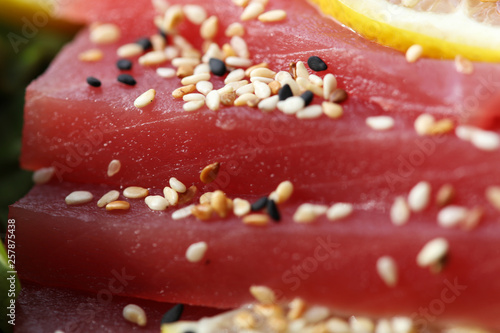 Raw tuna fish sashimi, decorated with black and white sesame, healthy eating concept