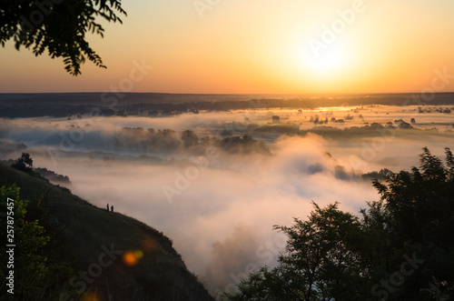 Dramatic sunrise over meadow and forest