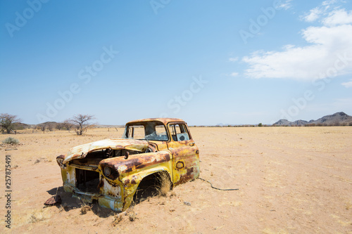 Car left a long time ago, dented and rusted, in absolute solitude of Damaraland, Namibia, Africa.