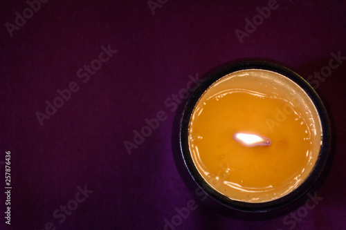Handmade candle in dark candlestick on table. Top view. Healthy lifestyle concept. Pharmacist consept.