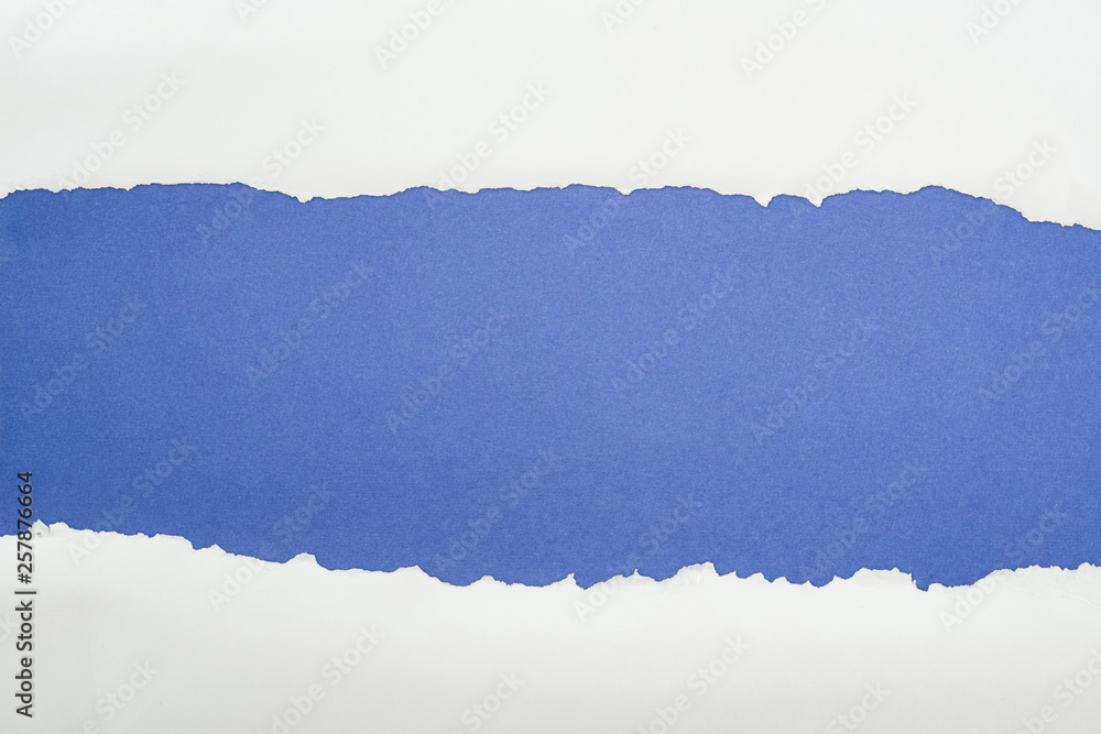 ragged white textured paper with copy space on deep blue background ragged white textured paper with copy space on deep blue background