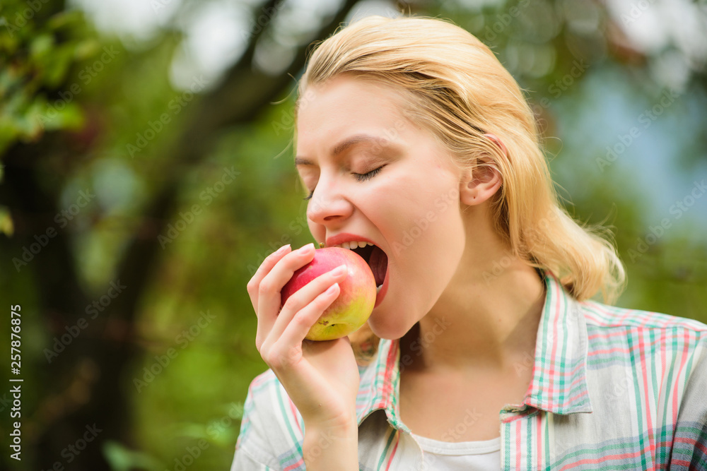 Eat fruits every day. Woman hold apple green garden background. Organic natural product. Girl gather apple harvest in own garden. Healthy lifestyle. Farmer girl hold apple. Local crops concept Eat fruits every day. Woman hold apple green garden background. Organic natural product. Girl gather apple harvest in own garden. Healthy lifestyle. Farmer girl hold apple. Local crops concept