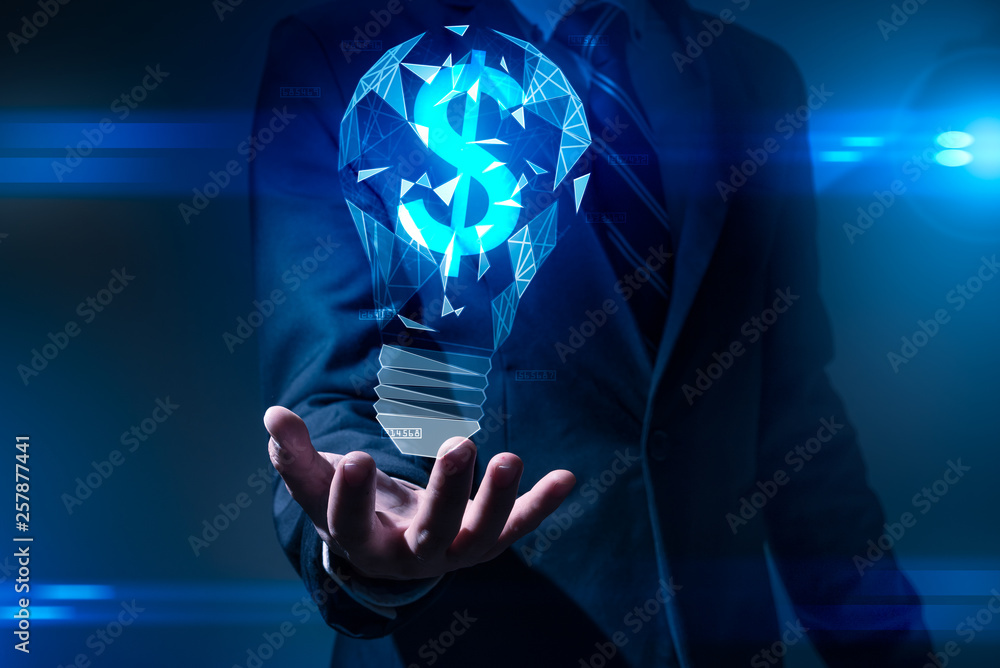 The abstract image of the hand holds the illumination lamp and the dollar sign inside. the concept of financial, idea, futuristic, business and technology.