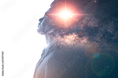 The double exposure image of the businessman thinking overlay with milky way galaxy image. the concept of imagination, technology, future and inspiration. photo