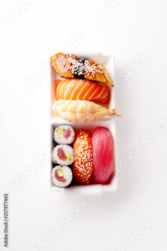 Creative layout with various sushi on white background. Shrimp, eel, salmon and tuna