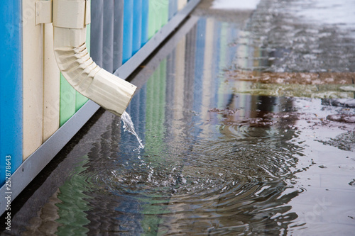 Картината върху платно White drainpipe with flooded pavement