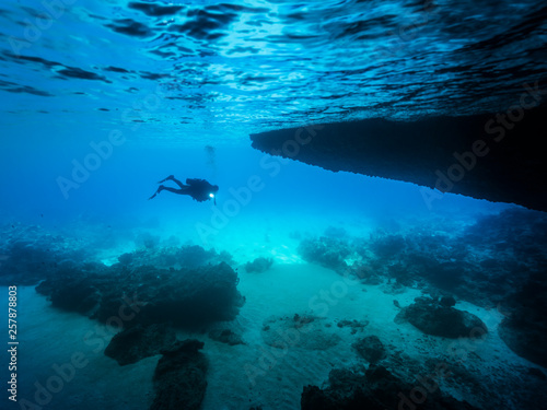 Seascape of coral reef in the Caribbean Sea around Curacao at dive site Blue Room, a special cave