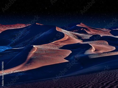 Fototapeta desert of namib at night with orange sand dunes and starry sky
