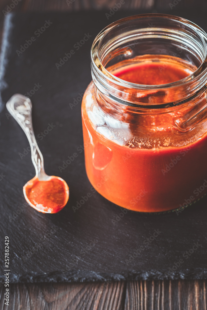 Barbecue sauce in the glass jar Barbecue sauce in the glass jar