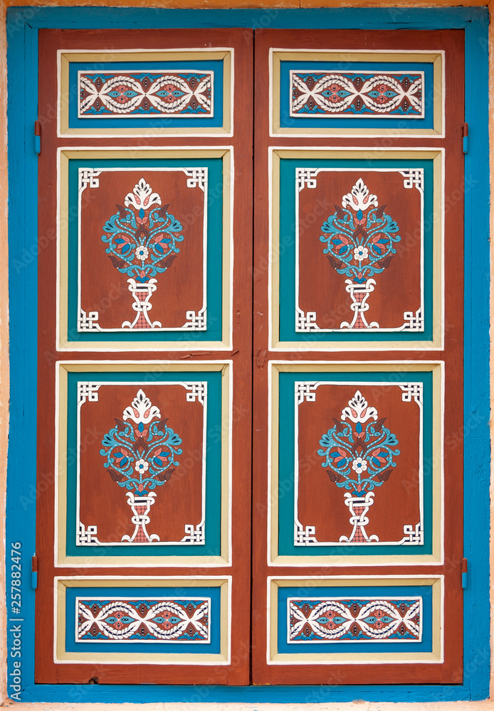 Beautiful ancient ornament painted on wooden shutter Beautiful ancient ornament painted on wooden shutter