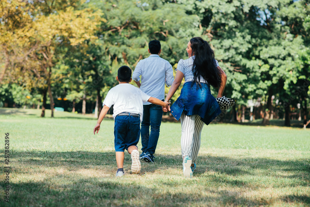 Happy children and parents playing in the park. Concept family relaxation.