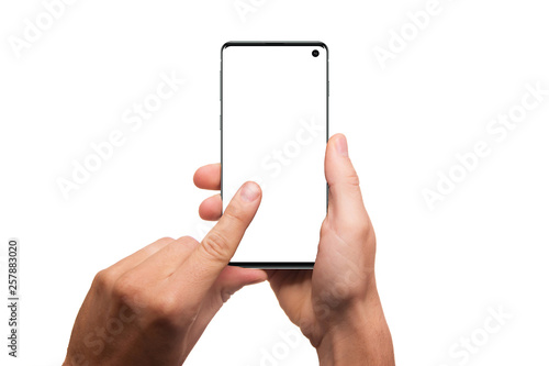 Hands holding smartphone with blank screen isolated on white background. Hand holding modern black phone in vertical position. Trendy phone mockup.