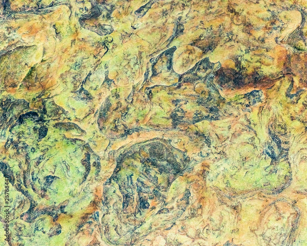 Green, orange, blue and yellow sedimentary rocks - colourful rock layers formed through cementation and deposition - abstract graphic design backgrounds, patterns, textures
