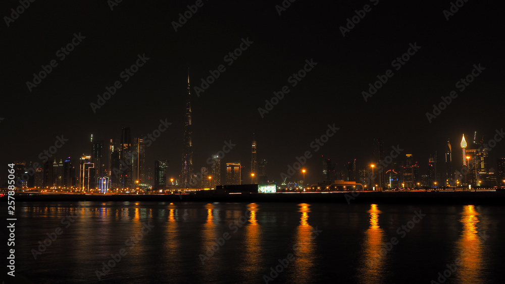 Modern city panoramic landscape by night. Beautiful Dubai cityscape. United Arab Emirates
