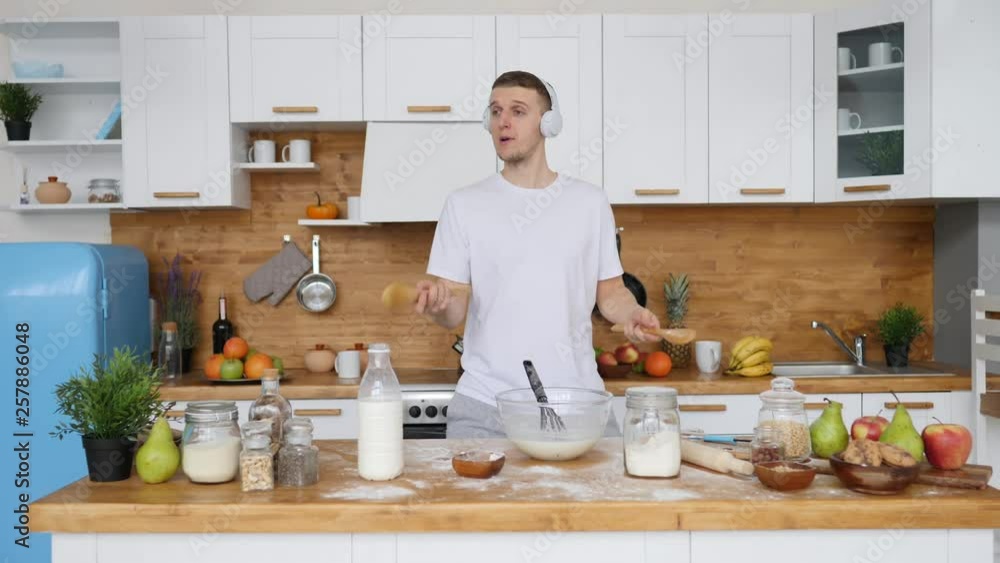 Good Morning Concept. Young Man Dancing And Cooking In Kitchen.