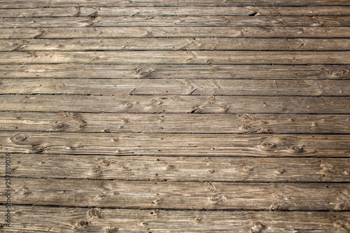 Textured detailed wooden flooring from the boards on the beach. Fragment. Texture. In the Algarve, Portugal.