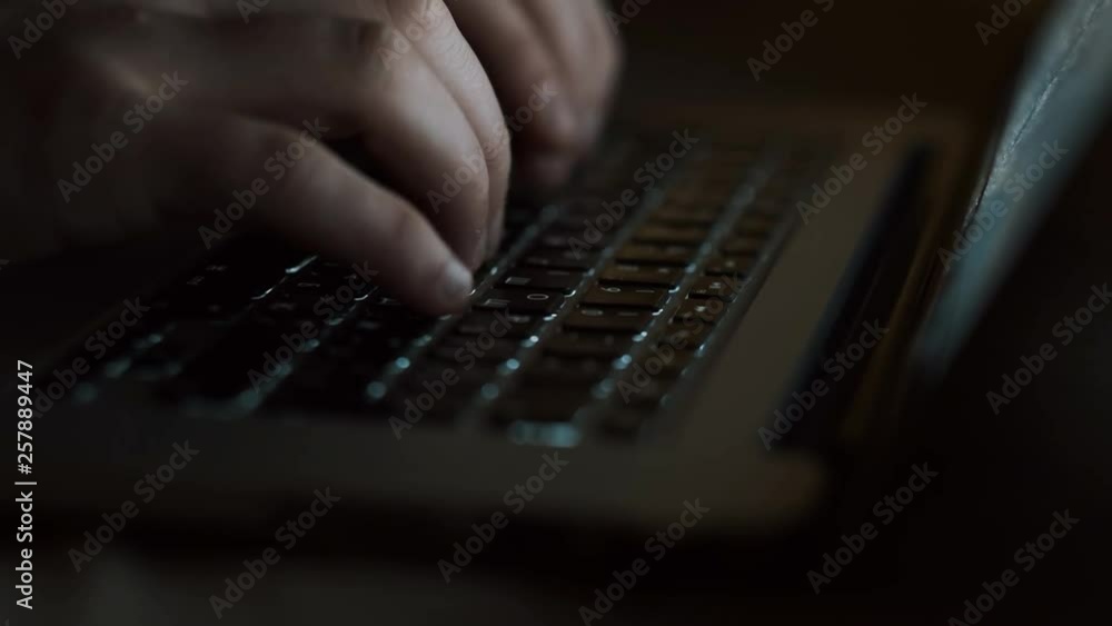 Young Guy Working At The Computer. Dark Room. Close-up. Young Guy Working At The Computer. Dark Room. Close-up.
