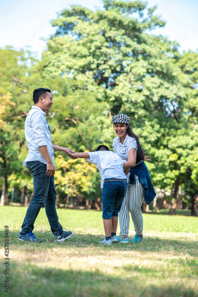 Fototapeta premium Happy children and parents playing in the park. Concept family relaxation.