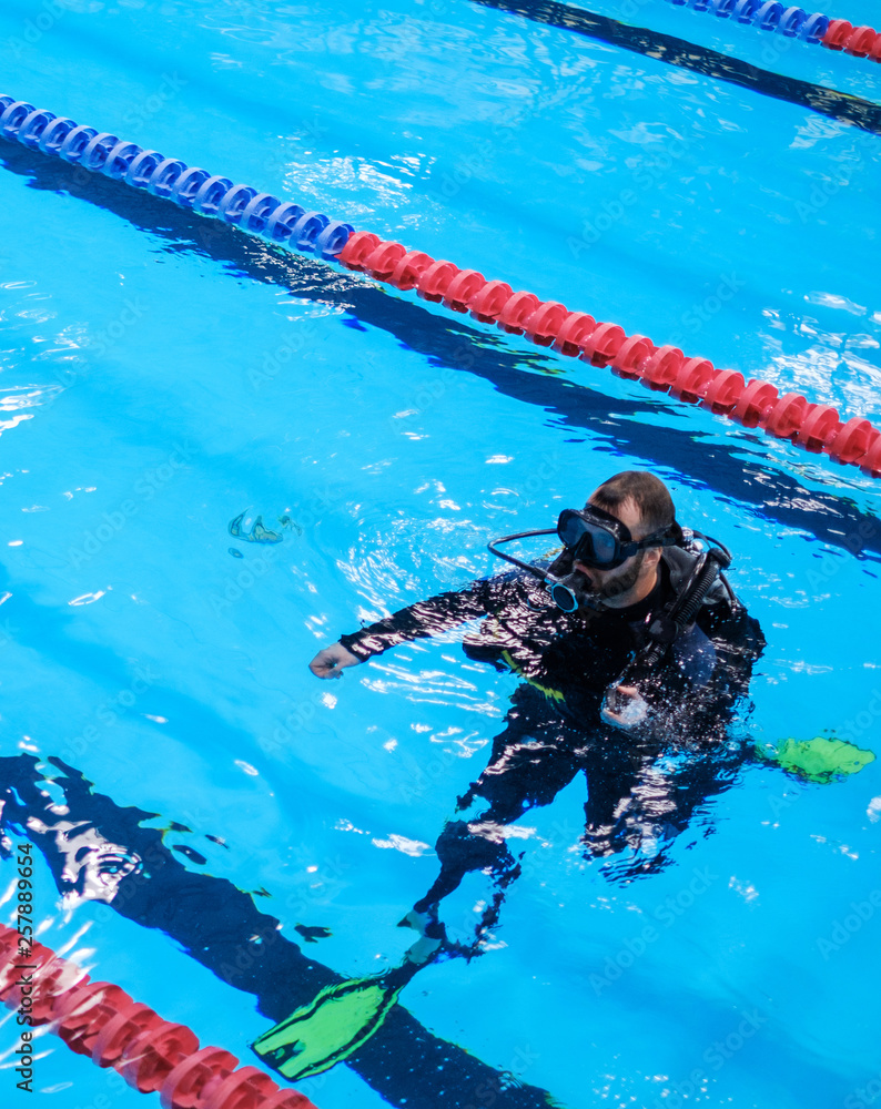 Scuba diver man training in a swimming pool